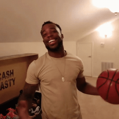 Man Holding Basketball Next To Cash Asty Box GIF