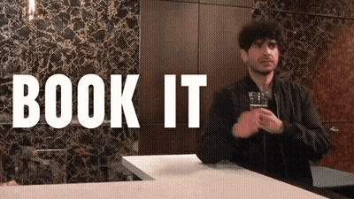 Man Holding Beer In Front Of Book It Wall GIF