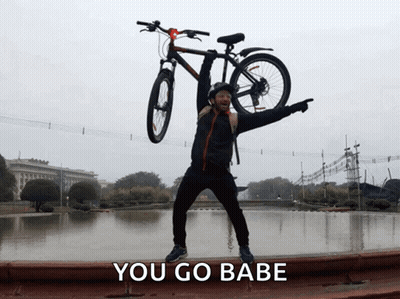 Man Holding Bicycle Overhead Saying You Go Babe GIF