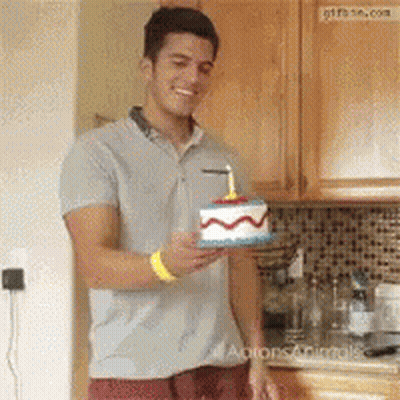 Man Holding Birthday Cake With Candle GIF