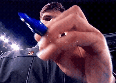Man Holding Blue Pen With Letter E On Jacket GIF