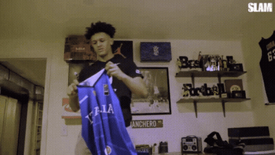 Man Holding Blue T.LA Shirt GIF