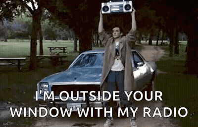 Man Holding Boombox Over Head In Park GIF