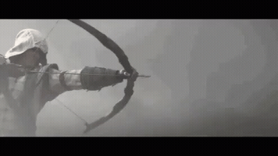 Man Holding Bow And Arrow In Foggy Background GIF