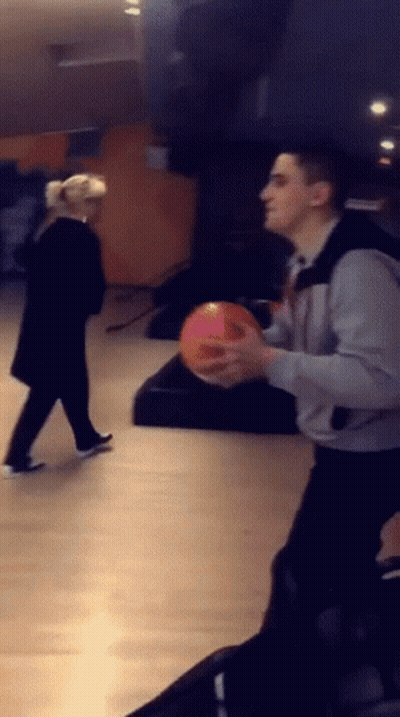 Man Holding Bowling Ball Woman Looking On GIF