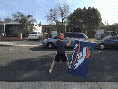 Man Holding Broncos Flag In Front Of Car GIF