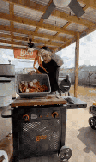 Man Holding Bucket On Head And Man On Cooler GIF
