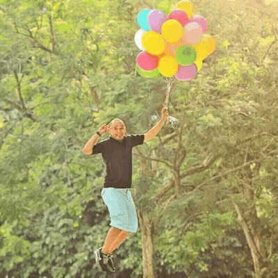 Man Holding Bunch Of Balloons GIF