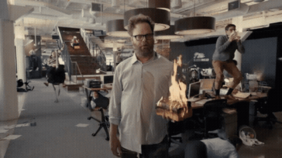 Man Holding Burning Log In Office GIF
