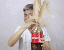 Man Holding Bursting Coke GIF