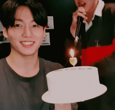 Man Holding Cake With Candle GIF