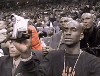 Man Holding Camera In Front Of Crowd GIF