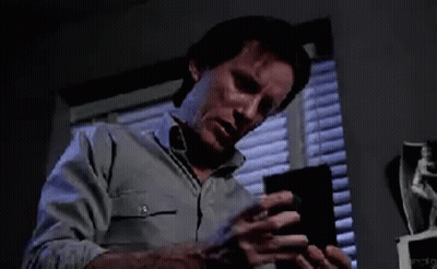 Man Holding CD In Front Of Window GIF