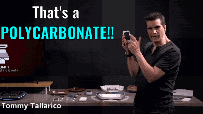 Man Holding Cellphone In Front Of That's A Polycarbonate Sign GIF