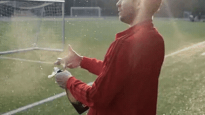 Man Holding Champagne On Soccer Field GIF