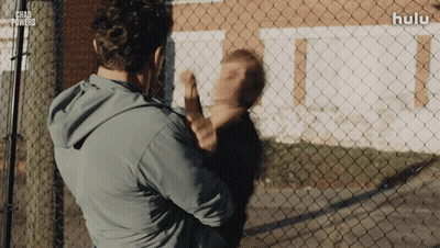 Man Holding Child In Front Of Chad Powers Fence GIF