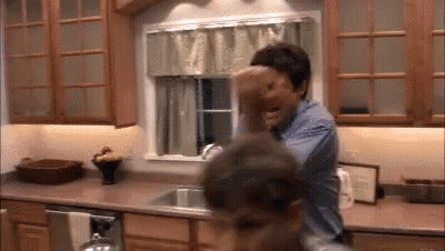 Man Holding Child in Kitchen