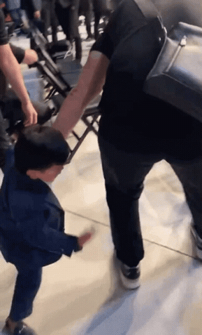 Man Holding Child's Hand Walking Down Hallway GIF