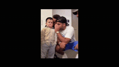 Man Holding Child With Another Man Behind GIF