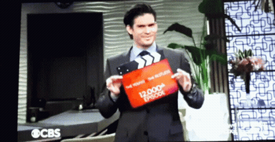 Man Holding Clapper Board Saying 12,000Th Episode GIF