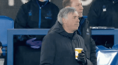 Man Holding Coffee Cup In Stadium GIF