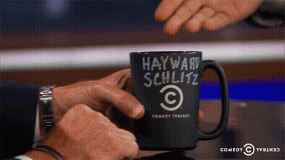 Man Holding Coffee Mug Saying Hayward Schlitz GIF