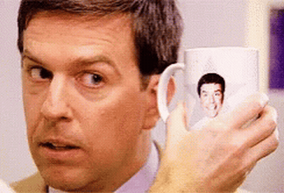 Man Holding Coffee Mug With Face GIF