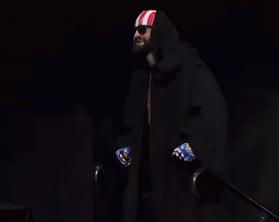 Man Holding Coors Light, Black Cape, Red-White-Blue Headband GIF