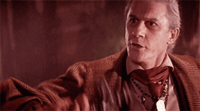 Man Holding Cross In Dark Room GIF