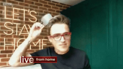 Man Holding Cup In Front Of Let Stay Home Sign GIF