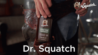 Man Holding Dr. Squatch Pine Tar Bottle GIF