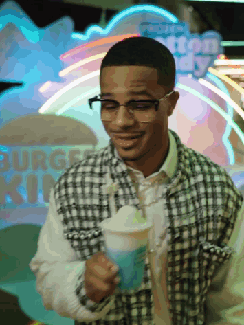Man Holding Drink In Front Of Burger King Neon Sign GIF