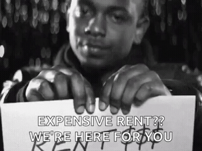 Man Holding Expensive Rent Sign