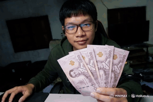 Man Holding Fan Of 1000 Bills GIF