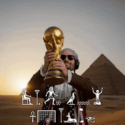 Man Holding FIFA World Cup Trophy In Front Of Pyramids GIF