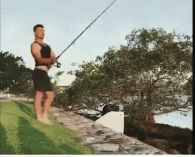 Man Holding Fishing Rod On Stone Wall GIF
