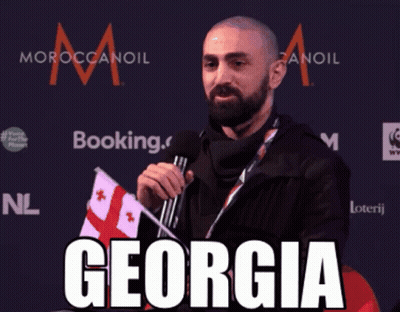 Man Holding Flag And Microphone Saying Georgia GIF