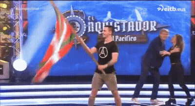 Man Holding Flag On Stage Saying El Pacifico GIF