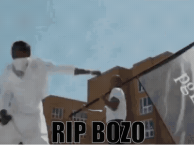 Man Holding Flag Saying Rip Bozo GIF