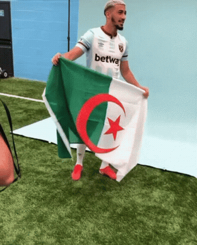 Man Holding Flag With Red Star And Green Crescent Moon GIF