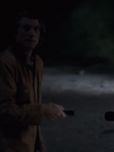 Man Holding Flashlight In Dark GIF