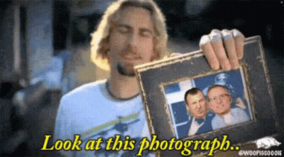 Man Holding Framed Picture Saying Look At This Photograph GIF