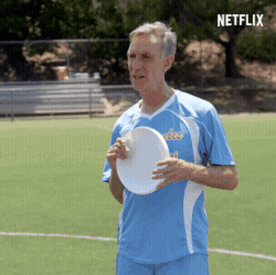 Man Holding Frisbee On Field With Netflix Logo GIF
