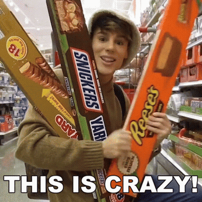 Man Holding Giant Snickers And Reese's Bars GIF