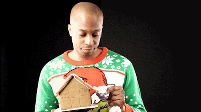 Man Holding Gingerbread House GIF