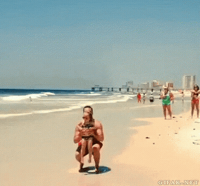 Man Holding Girl Up In The Air On Beach GIF