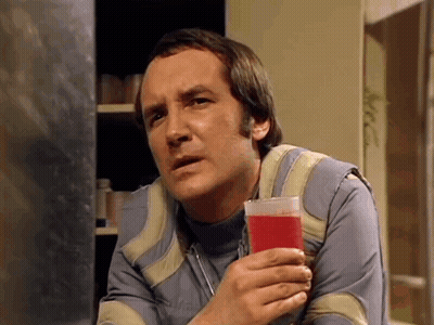 Man Holding Glass Of Red Liquid GIF