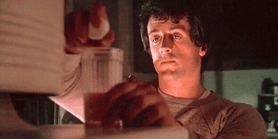 Man Holding Glass Of Water In Front Of Microwave GIF