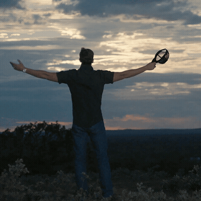 Man Holding Glass With Arms Outstretched GIF