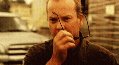 Man Holding Glasses Covering Mouth GIF